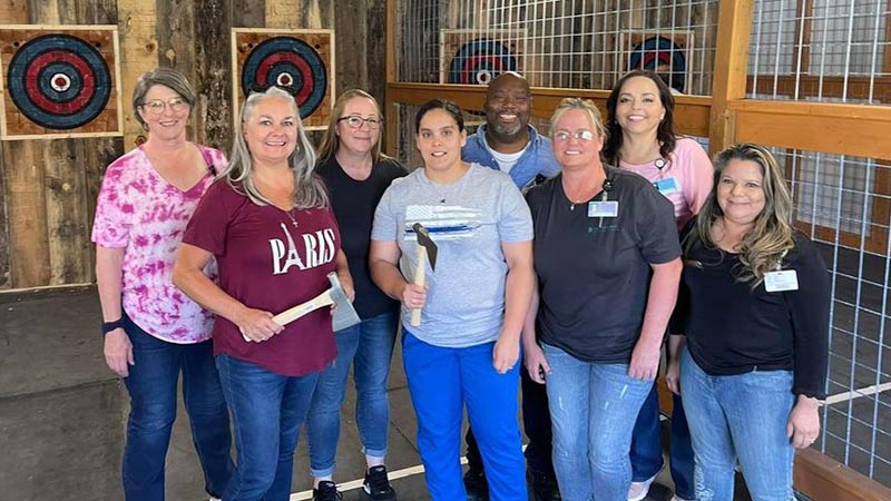A group of people axe throwing