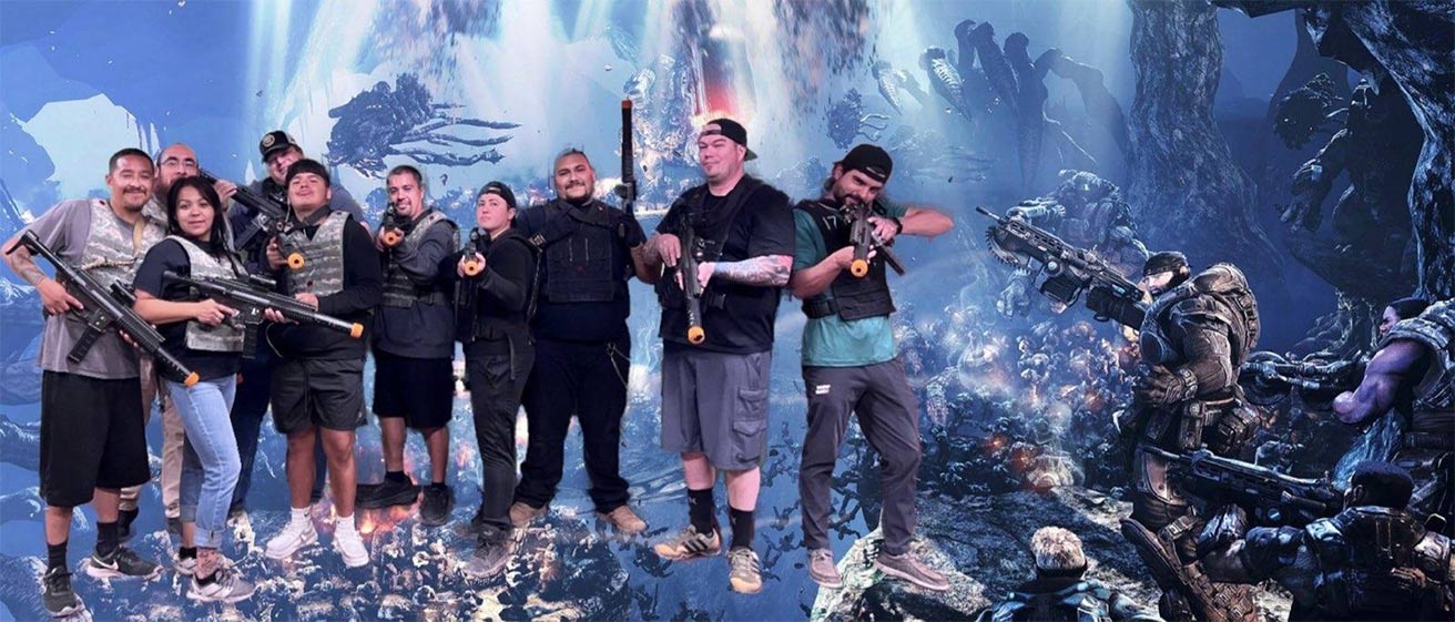 A group posing with laser tag guns