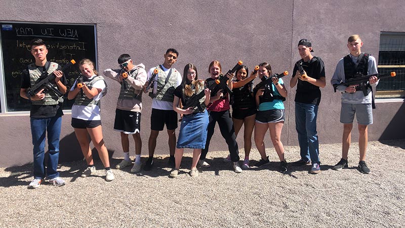 A group outdoors playing laser tag