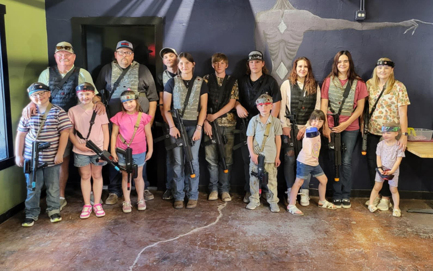 A group of girls outside playing laser tag
